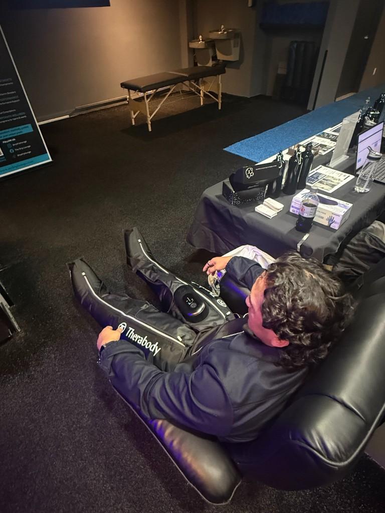 Client using Therabody compression boots at NY Drip Lounge